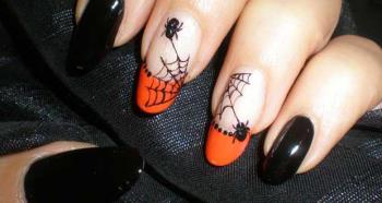 Halloween nail art with spiders and cobwebs