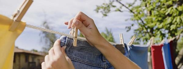 Why are clothes dried in the dryer soft and in the sun hard and rough?